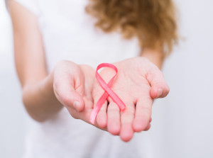 girl  holding pink breast cancer awareness ribbon