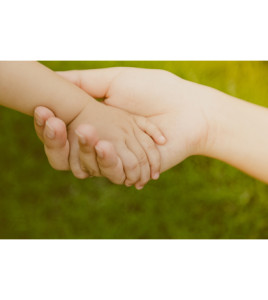 Mother holding baby hand ( Filtered image processed vintage effect. )